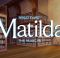 A library with the Matilda logo curtain warmer